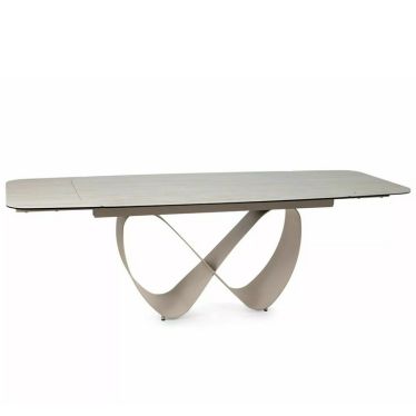 Table AMBRE vue de face avec son plateau en céramique et son pied central aux courbes d'infini